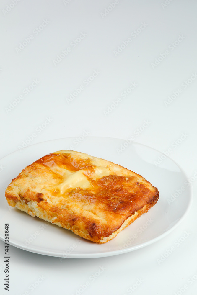 cottage cheese casserole in white plate closeup with copy space. cottage cheese casserole isolated om white