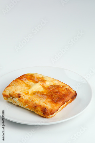 cottage cheese casserole in white plate closeup with copy space. cottage cheese casserole isolated om white © northernrf