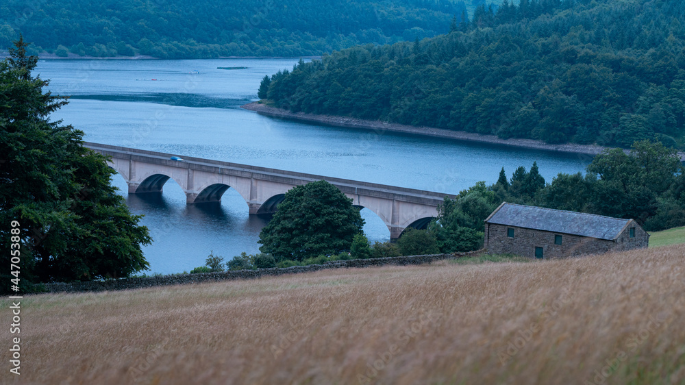 Ladybower Reservoir, Peak District UK: Car crossing the viaduct Ladybower Reservoir, Peak District UK: Car crossing the viaduct