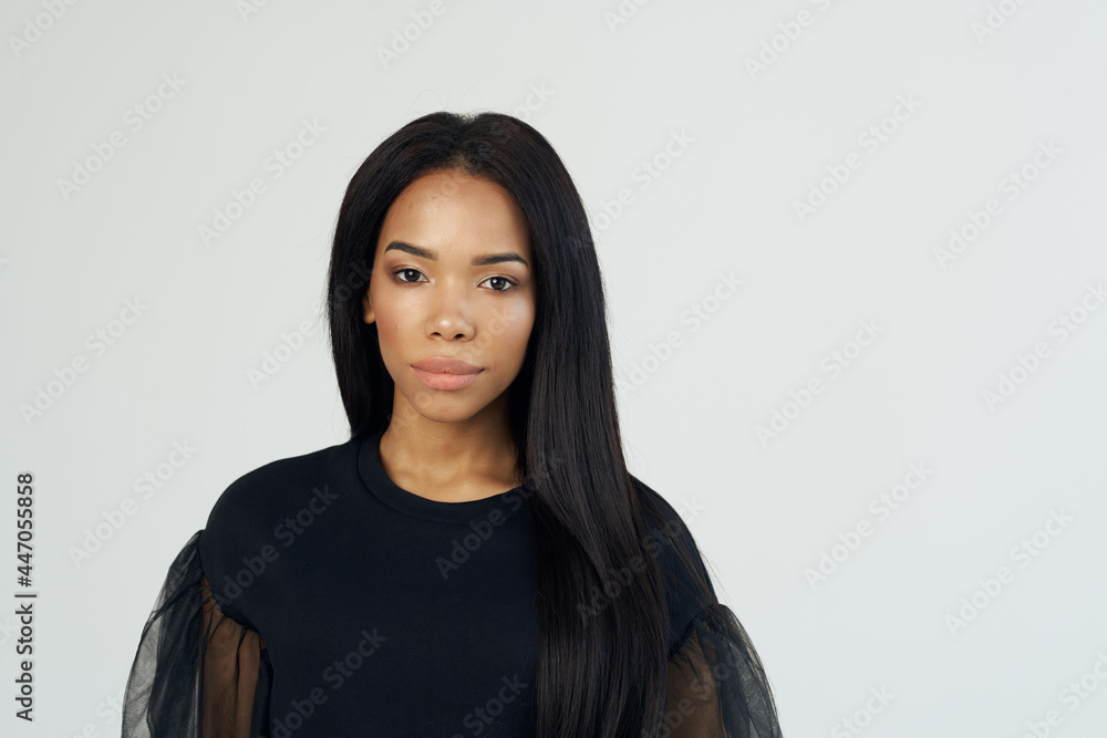 pretty woman with fashionable hairstyle posing black shirt light background pretty woman with fashionable hairstyle posing black shirt light background