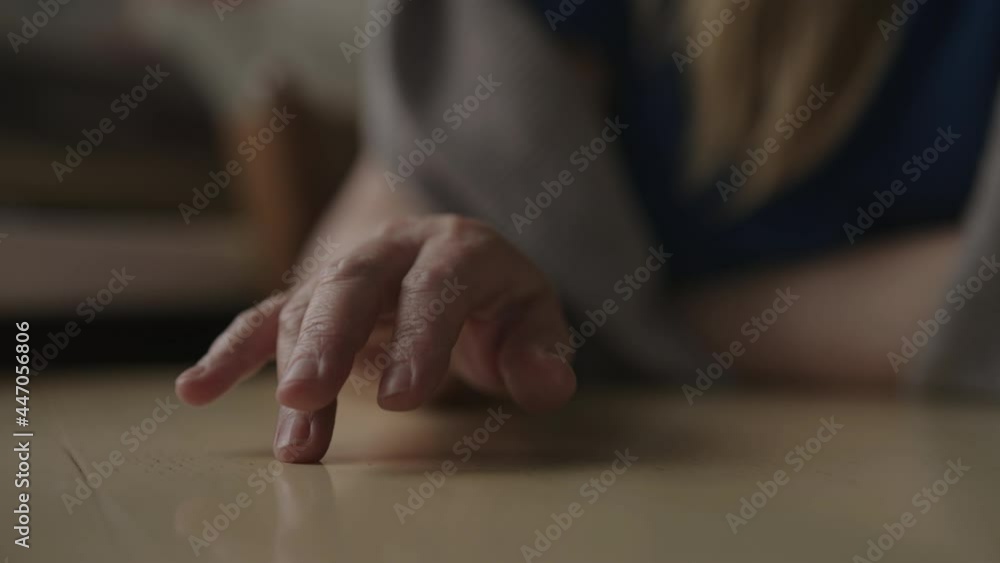 Slow motion handheld shot of woman sitting behind the table and finger tapping, waiting for something Slow motion handheld shot of woman sitting behind the table and finger tapping, waiting for something