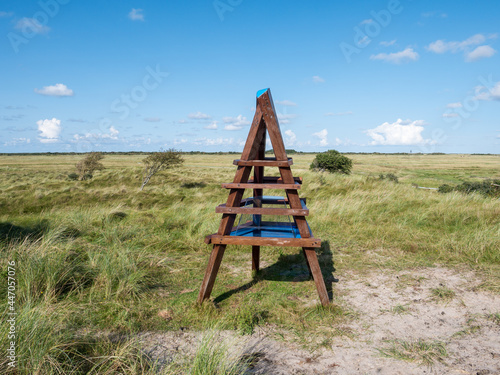 Sculpture of beacon and Kobbeduin dunes on West Frisian island Schiermonnikoog, Netherlands