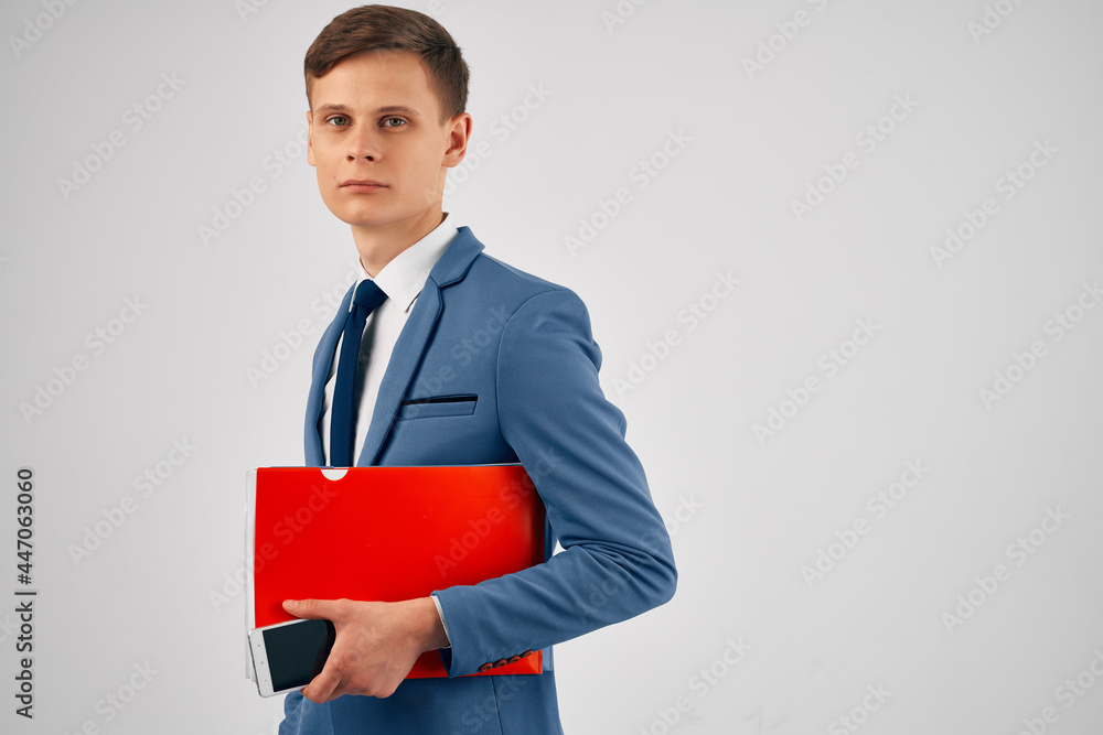 a man in a suit with a red folder in his hands with a phone communication a man in a suit with a red folder in his hands with a phone communication