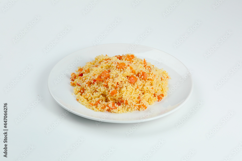 couscous with carrots in white plate closeup. couccous isolated on white background couscous with carrots in white plate closeup. couccous isolated on white background