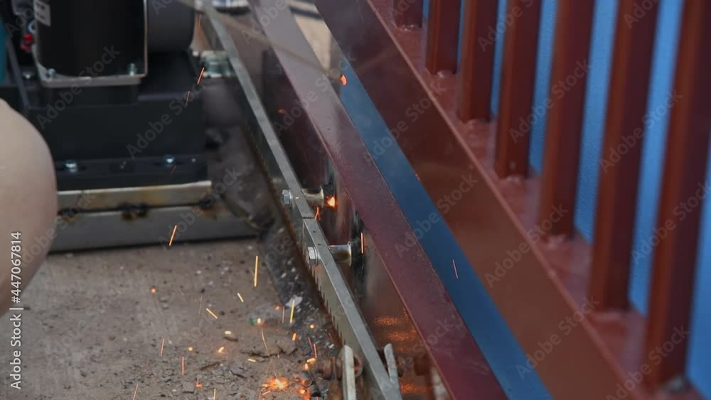 Welder man under welding steel door gate for installation automatic gate door is home security system. 