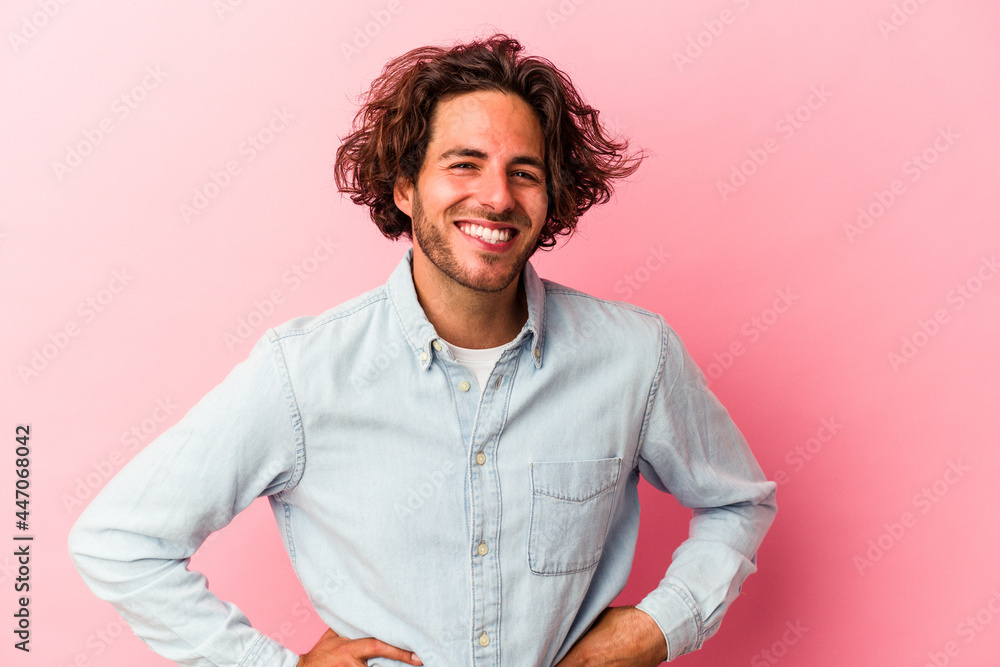 Young caucasian man isolated on pink bakcground happy, smiling and cheerful. Young caucasian man isolated on pink bakcground happy, smiling and cheerful.