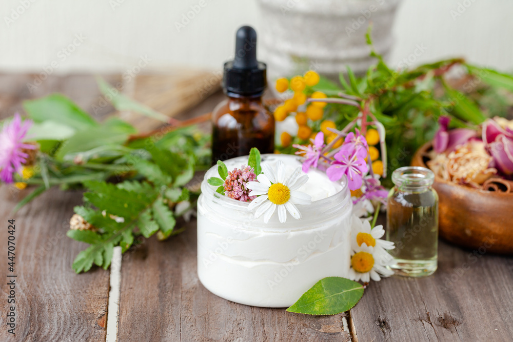 Concept of herbal, flower extracts in cosmetics. Natural organic ingredients, pure extract for beautiful healthy skin, essential oil, aromatherapy. Wooden background, close up