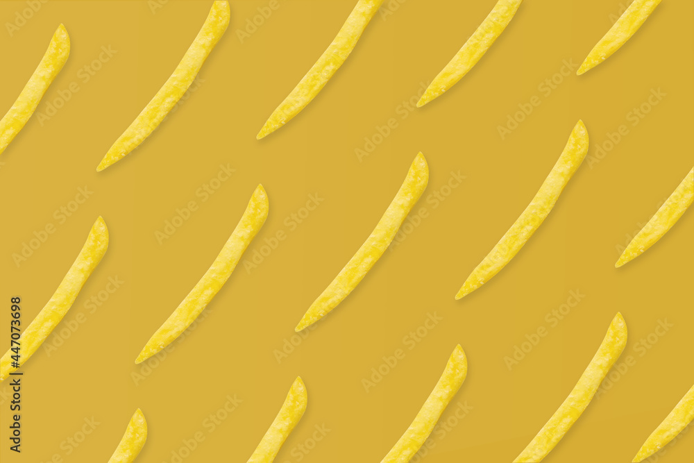 Fototapeta premium french fries pattern on yellow background top view flat lay