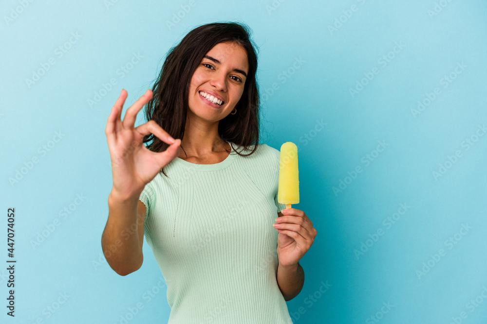 Young caucasian woman holding an ice cream isolated on blue background Young caucasian woman holding an ice cream isolated on blue background cheerful and confident showing ok gesture. Young caucasian woman holding an ice cream isolated on blue background Young caucasian woman holding an ice cream isolated on blue background cheerful and confident showing ok gesture.