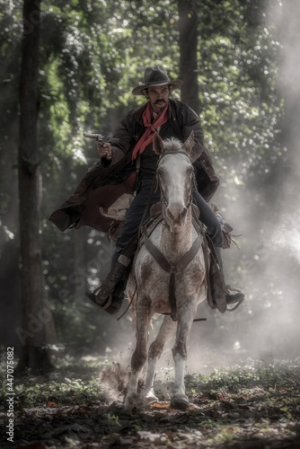 Cowboy is riding a horse and holding a short gun in his hand, ready for shooting. Cowboy concept.