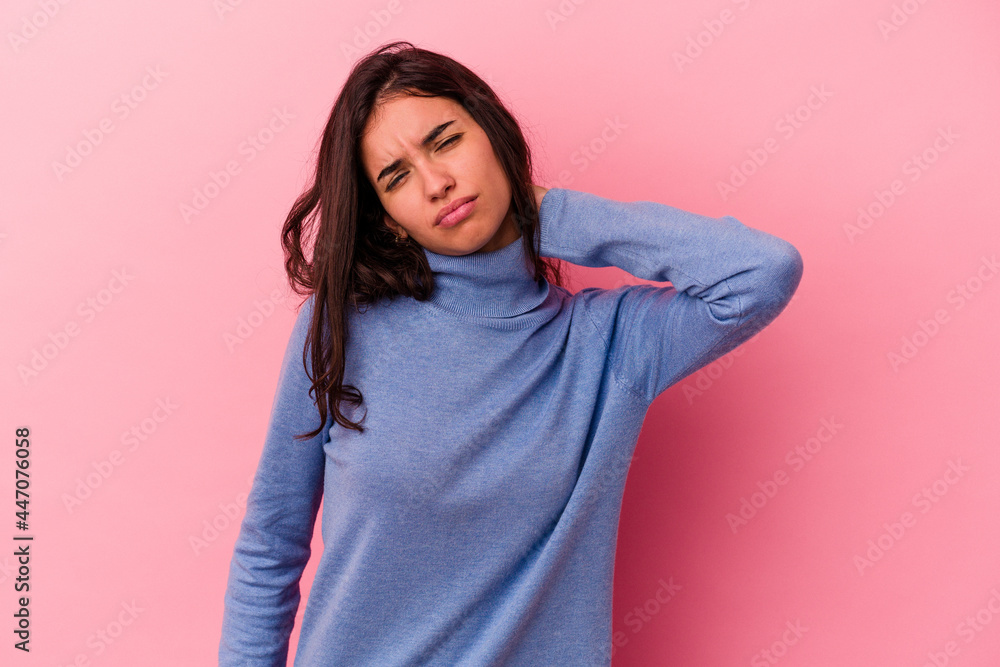 Young caucasian woman isolated on pink background having a neck pain due to stress, massaging and touching it with hand. Young caucasian woman isolated on pink background having a neck pain due to stress, massaging and touching it with hand.