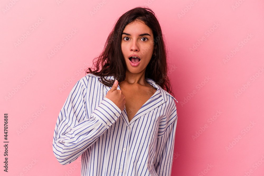 Young caucasian woman isolated on pink background surprised pointing with finger, smiling broadly. Young caucasian woman isolated on pink background surprised pointing with finger, smiling broadly.
