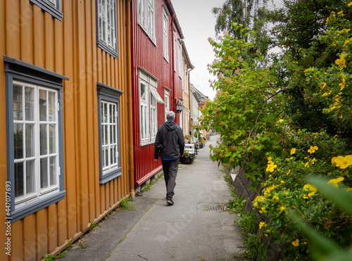 Wallpaper Mural Tourist on narrow street with traditional colourful wooden houses in Trondheim Torontodigital.ca