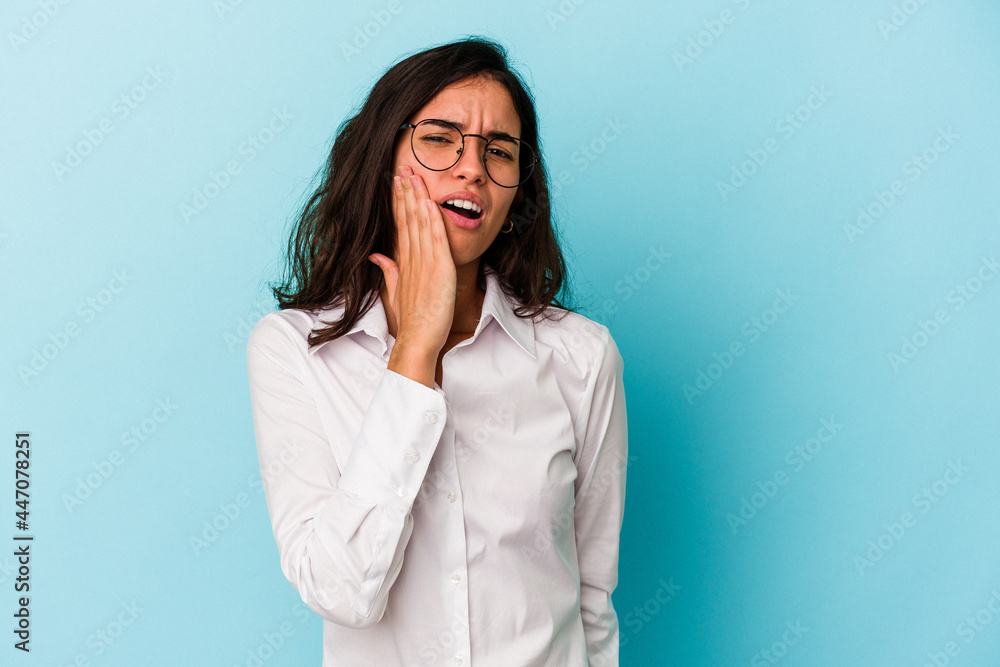 Young caucasian woman isolated on blue background yawning showing a tired gesture covering mouth with hand. Young caucasian woman isolated on blue background yawning showing a tired gesture covering mouth with hand.