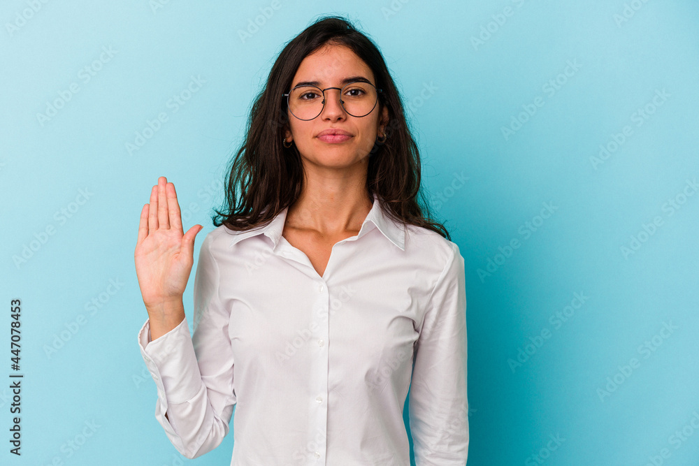 Young caucasian woman isolated on blue background smiling cheerful showing number five with fingers. Young caucasian woman isolated on blue background smiling cheerful showing number five with fingers.