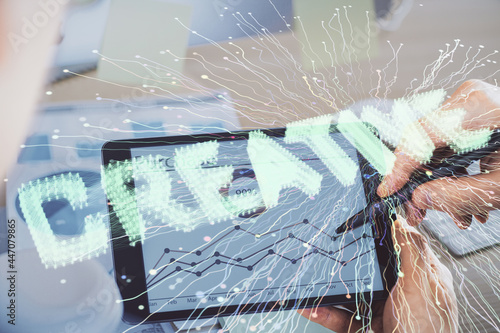 Double exposure of man's hands holding and using a mobile device and creative hologram drawing.