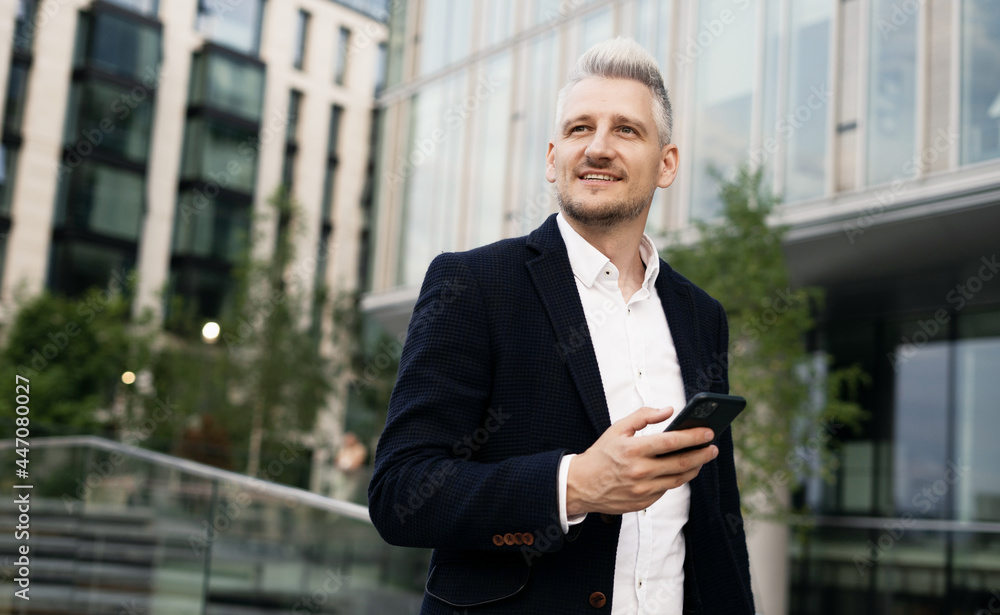 The lawyer communicates by phone via messages with the client. A business man is dressed in a stylish jacket.The manager is an adult of Caucasian appearance, a stylish gray-haired man. The lawyer communicates by phone via messages with the client. A business man is dressed in a stylish jacket.The manager is an adult of Caucasian appearance, a stylish gray-haired man.