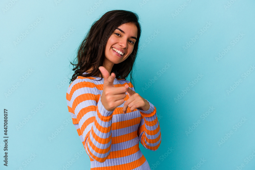 Young caucasian woman isolated on blue background pointing to front with fingers. Young caucasian woman isolated on blue background pointing to front with fingers.