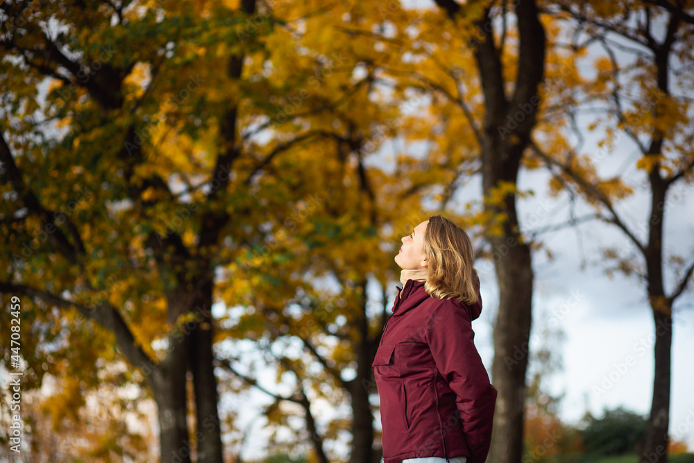 Playful young woman enjoying the fall yellow leaves in the autumn park. People, feelings, seasonal dating concept Playful young woman enjoying the fall yellow leaves in the autumn park. People, feelings, seasonal dating concept