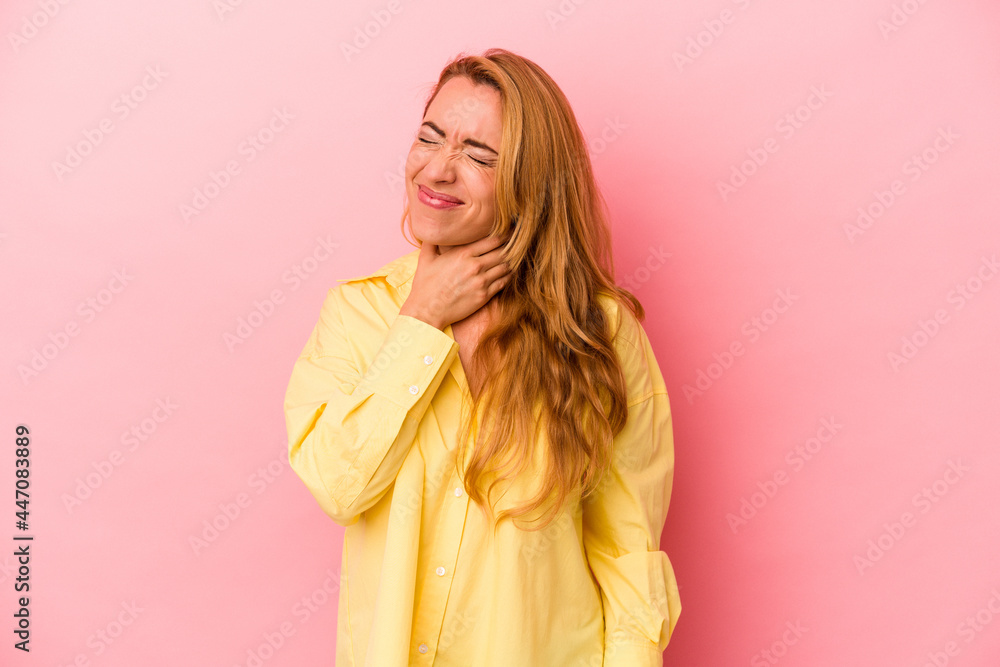 Caucasian blonde woman isolated on pink background touching back of head, thinking and making a choice. Caucasian blonde woman isolated on pink background touching back of head, thinking and making a choice.