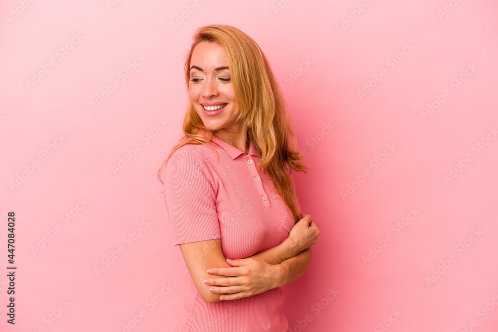 Caucasian blonde woman isolated on pink background laughing and having fun. Caucasian blonde woman isolated on pink background laughing and having fun.