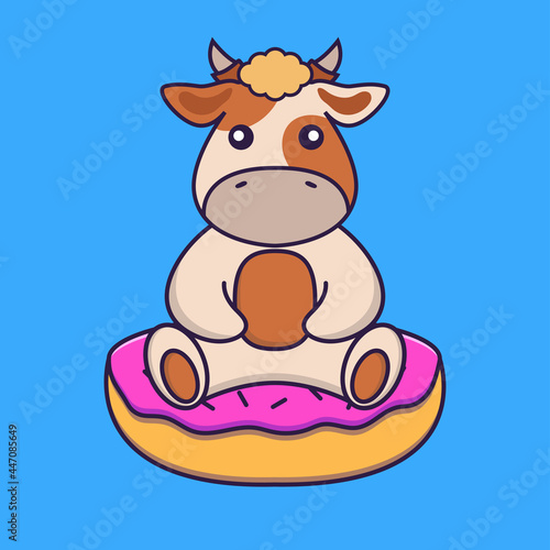 Cute cow is sitting on donuts.