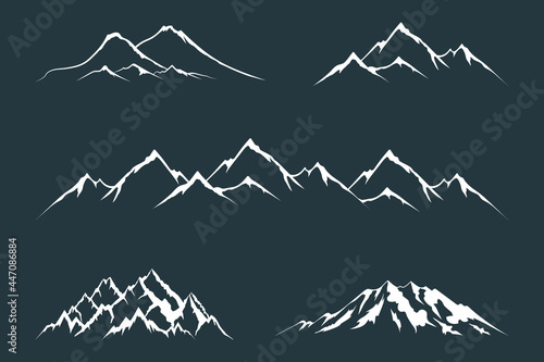 Set of everest and alpine mountain silhouettes. Vector isolated illustration with rocky and snowy peaks.