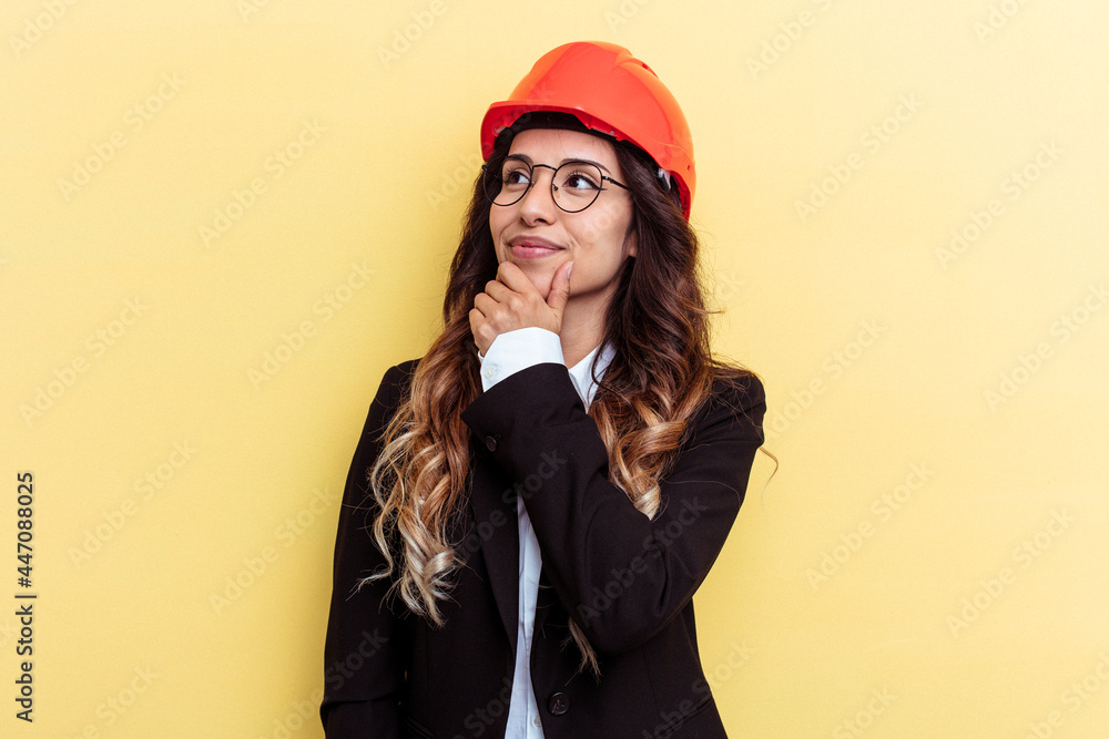 Young architect mixed race woman isolated on yellow background looking sideways with doubtful and skeptical expression. Young architect mixed race woman isolated on yellow background looking sideways with doubtful and skeptical expression.