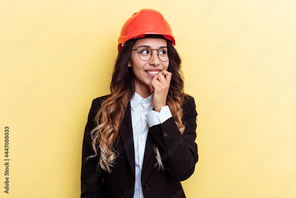 Young architect mixed race woman isolated on yellow background relaxed thinking about something looking at a copy space. Young architect mixed race woman isolated on yellow background relaxed thinking about something looking at a copy space.