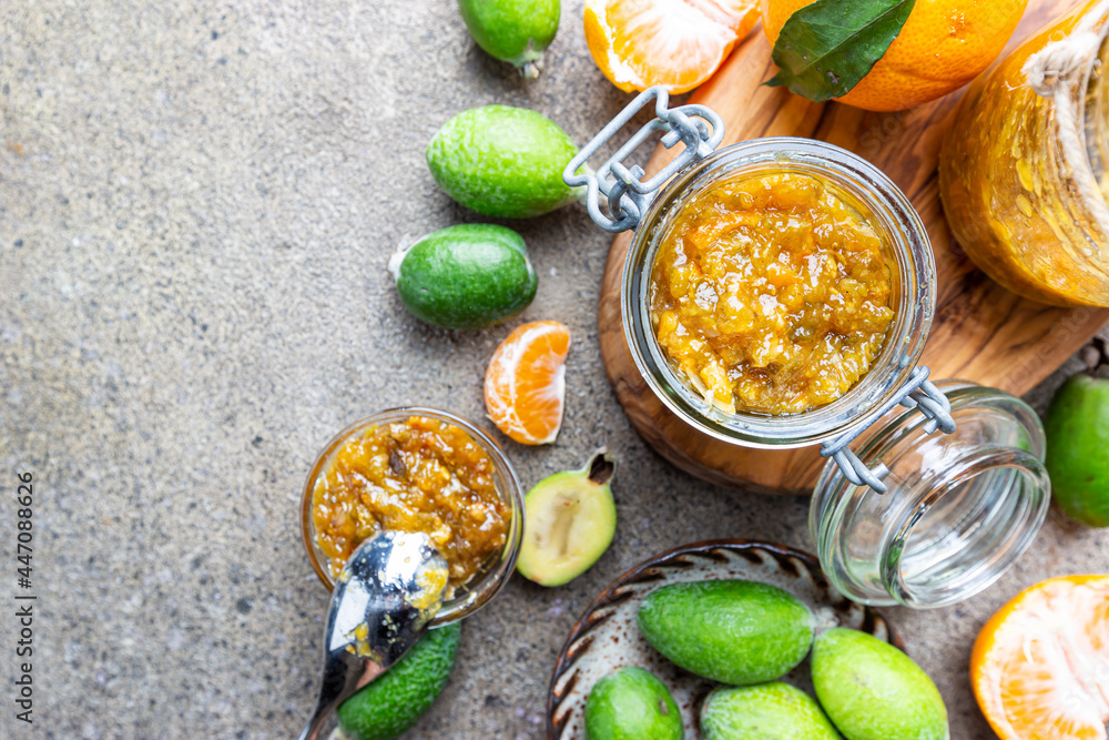 Tropical fruit preserves, homemade feijoa and tangerine jam with fresh fruits, top view Tropical fruit preserves, homemade feijoa and tangerine jam with fresh fruits, top view