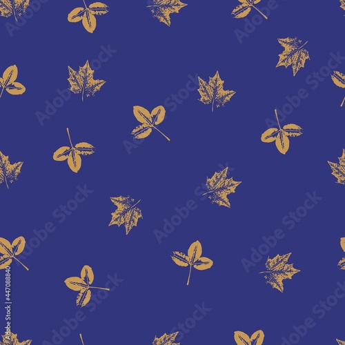 Handmade seamless pattern with yellow leaves on a blue saturated background.  Printing on fabric  wallpaper  packaging  stylization under a stamp or an imprint of summer leaves  rustic or boho 