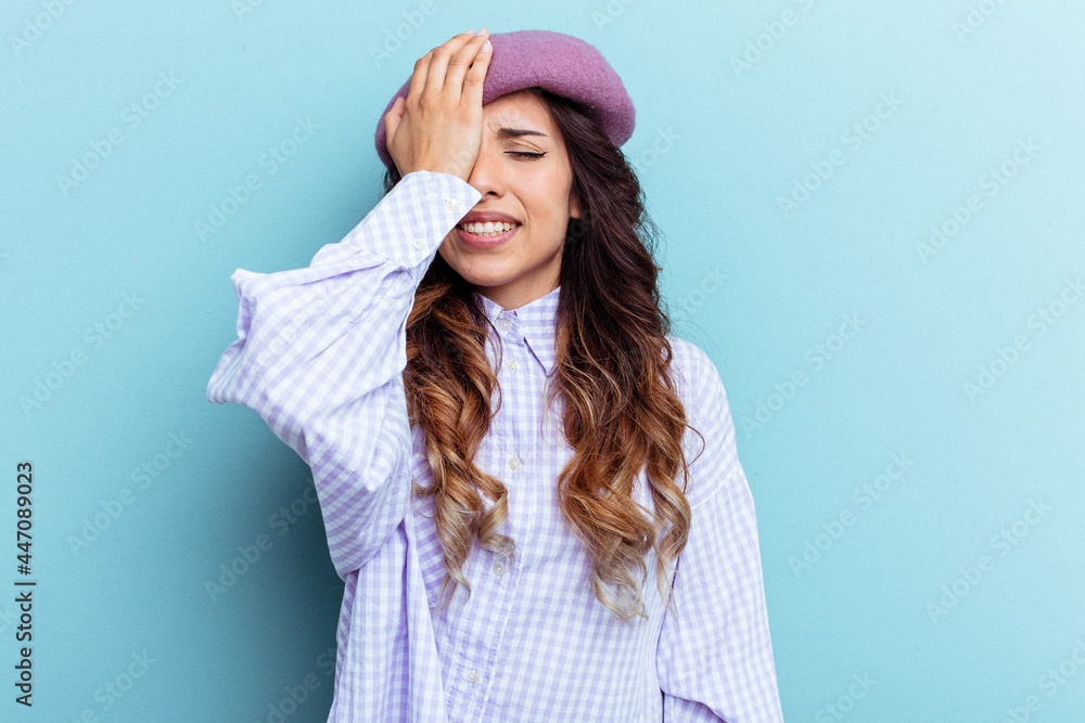 Young mexican woman isolated on blue background forgetting something, slapping forehead with palm and closing eyes. Young mexican woman isolated on blue background forgetting something, slapping forehead with palm and closing eyes.