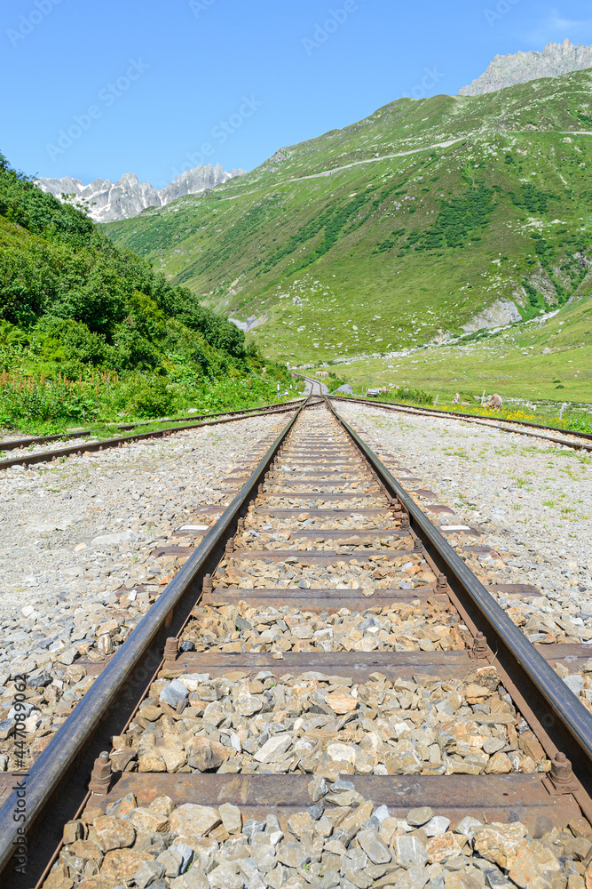 Fototapeta premium Railroad tracks at a fork. Fourka 2163 m. Switzerland. Alps.