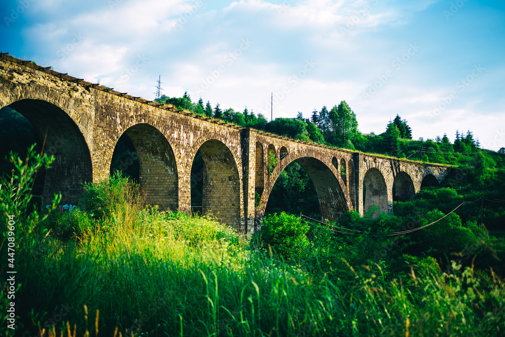 ancient stone viaduct in the rays of the setting sun