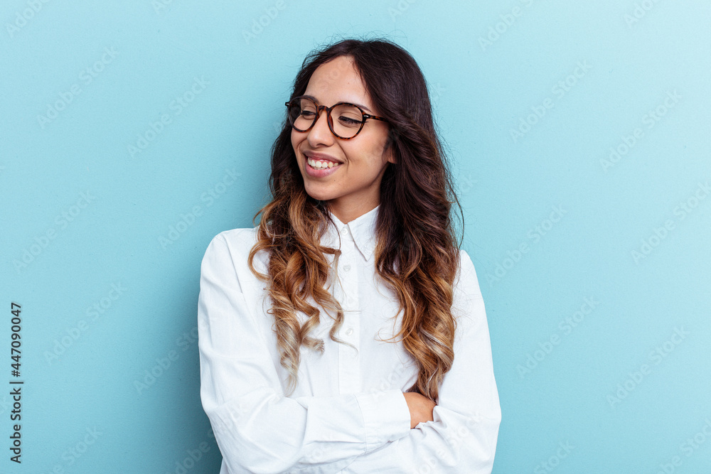 Young mexican woman isolated on blue background smiling confident with crossed arms. Young mexican woman isolated on blue background smiling confident with crossed arms.