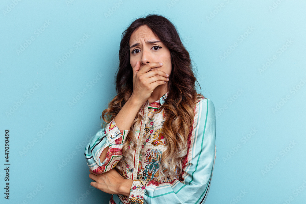 Young mexican woman isolated on blue background scared and afraid. Young mexican woman isolated on blue background scared and afraid.