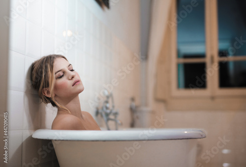 young woman relaxed in bathtub photo