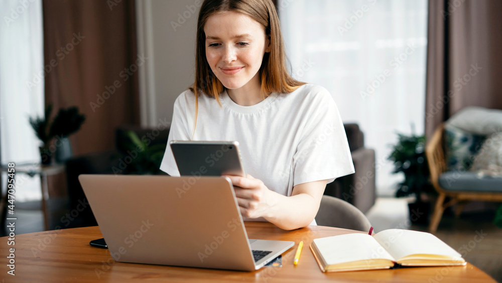 A young female freelance blogger works at home on a laptop. A smart student does lessons remotely online. Writes a letter to clients by email. A young female freelance blogger works at home on a laptop. A smart student does lessons remotely online. Writes a letter to clients by email.