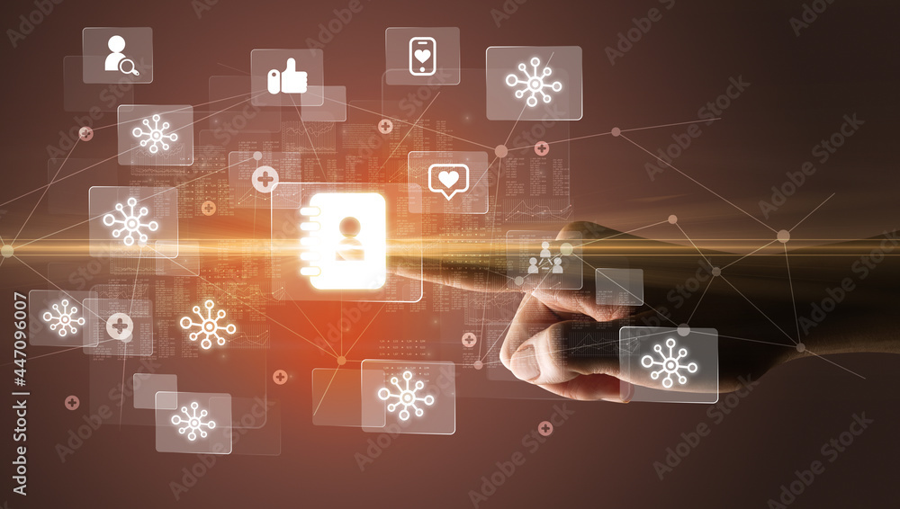 Hand pressing social media multimedia application screen with media icons on futuristic concept Hand pressing social media multimedia application screen with media icons on futuristic concept