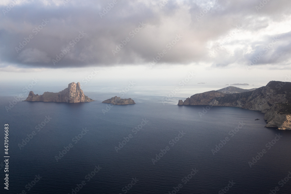 Aerial view of es Vedra island with the clouds in Ibiza, Spain, view of Ibiza island from the plane Aerial view of es Vedra island with the clouds in Ibiza, Spain, view of Ibiza island from the plane