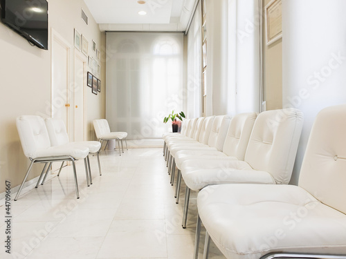 Bright waiting room in private dental clinic, white waiting hall interior in private hospital