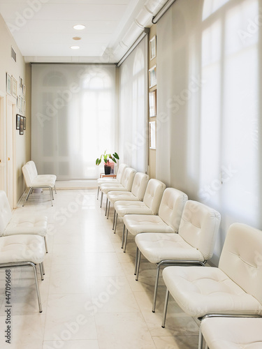 Bright waiting room in private dental clinic, white waiting hall interior in private hospital