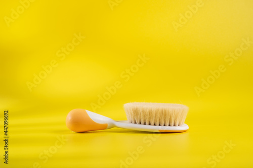 Comb baby's hair on a yellow background