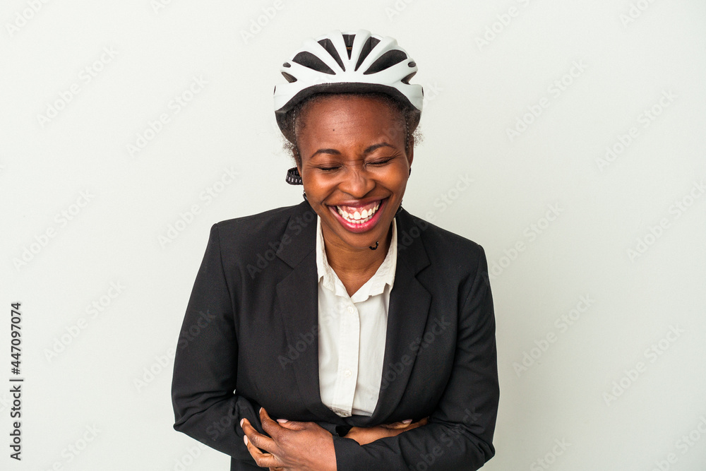 Young business african american woman wearing a bike helmet isolated on white background laughing and having fun. Young business african american woman wearing a bike helmet isolated on white background laughing and having fun.