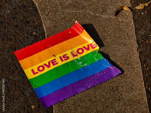 Obraz na płótnie A rainbow flag lies on the ground w salonie