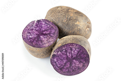 Fresh purple potatoes isolated on a white background.