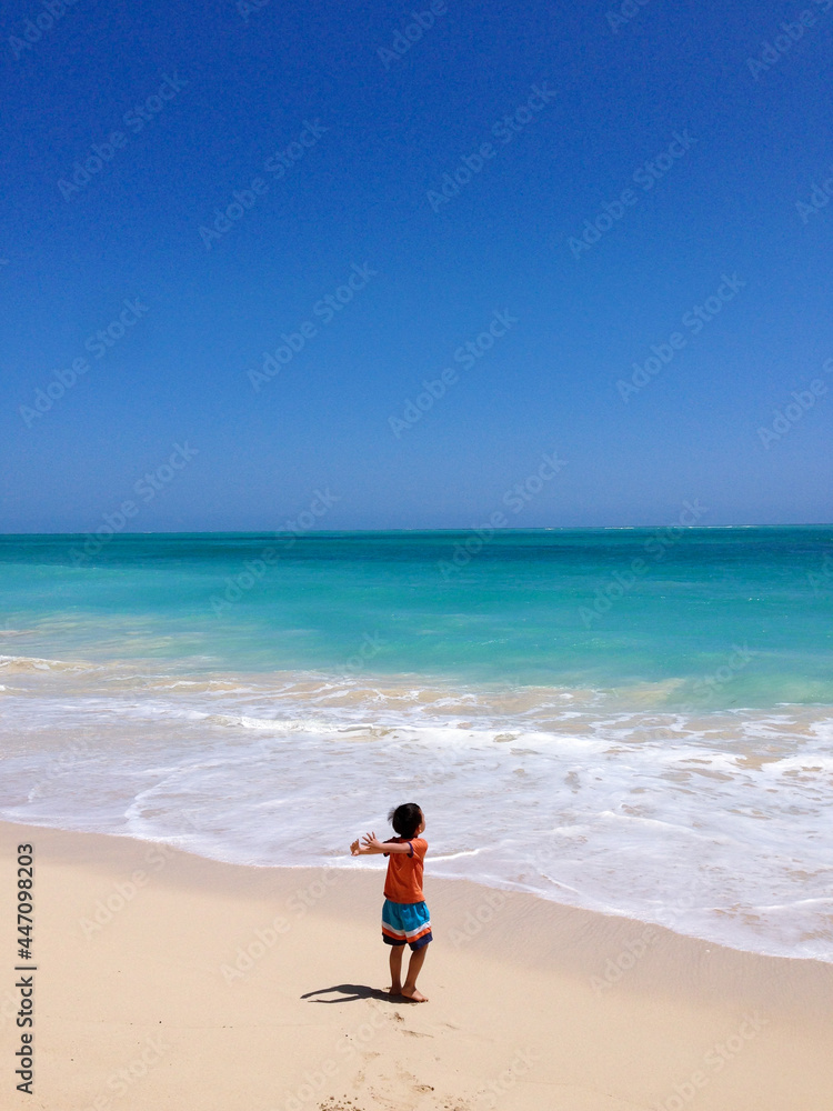 child on the beach in Hawaii.