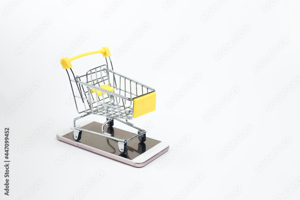 Shopping cart on smartphone white background. Shopping online supermarket on internet. business sale purchases digital marketing.