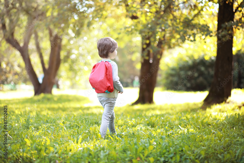 Children with briefcases for a walk in the park. School break. The beginning of the children's studies. Children with briefcases for a walk in the park. School break. The beginning of the children's studies.