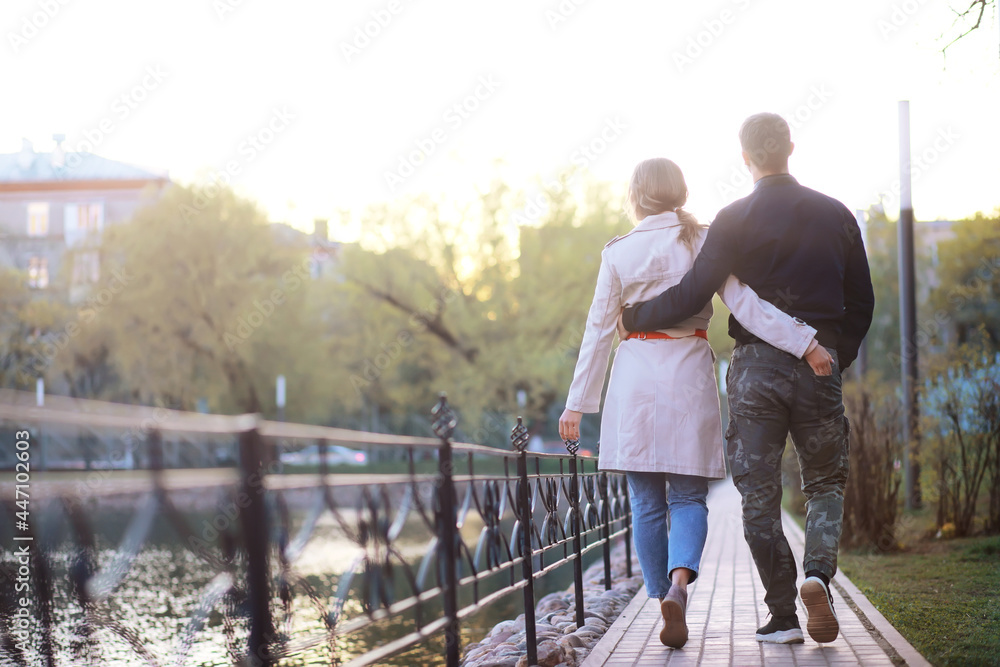 A man and a girl in love on a first date in an autumn city park. A man and a girl in love on a first date in an autumn city park.
